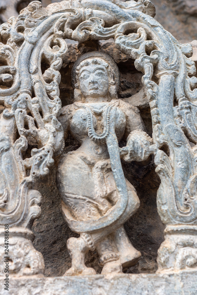 Belur, Karnataka, India - November 2, 2013: Chennakeshava Temple building. White beige stone statue of female figure called shilabalika, celestial dancer. 