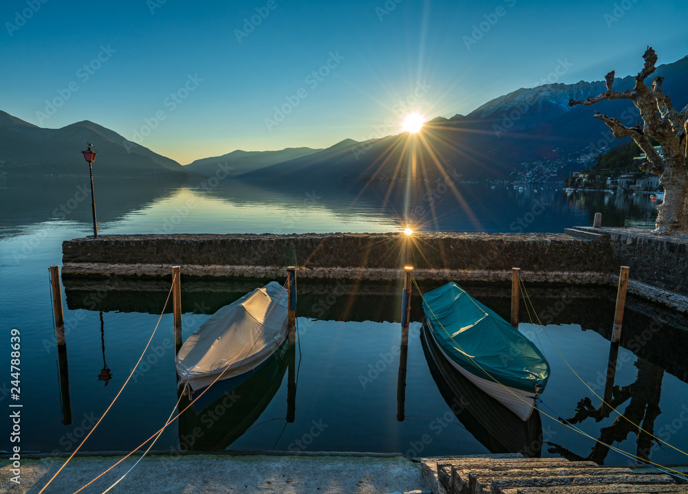 Boats in marina of Ascona under evening sun