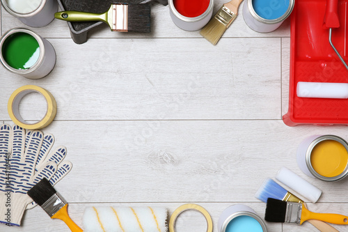 Fotografie Flat lay composition with cans of paint and decorator tools on wooden background