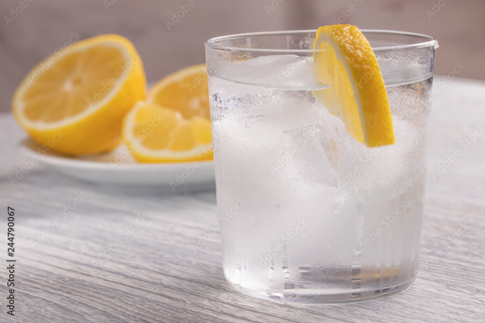Refreshing cold water with lemon. With ice. Ready to eat. Next is a knife after cutting fruit. Misted glass. Refreshing cold water with lemon. With ice. Ready to eat. Next is a knife after cutting fruit. Misted glass.