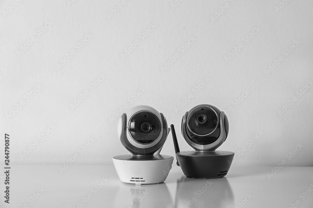 Modern CCTV security cameras on white background. Space for text Modern CCTV security cameras on white background. Space for text