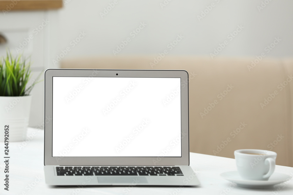 Fototapeta premium Laptop with blank screen on table indoors. Space for text