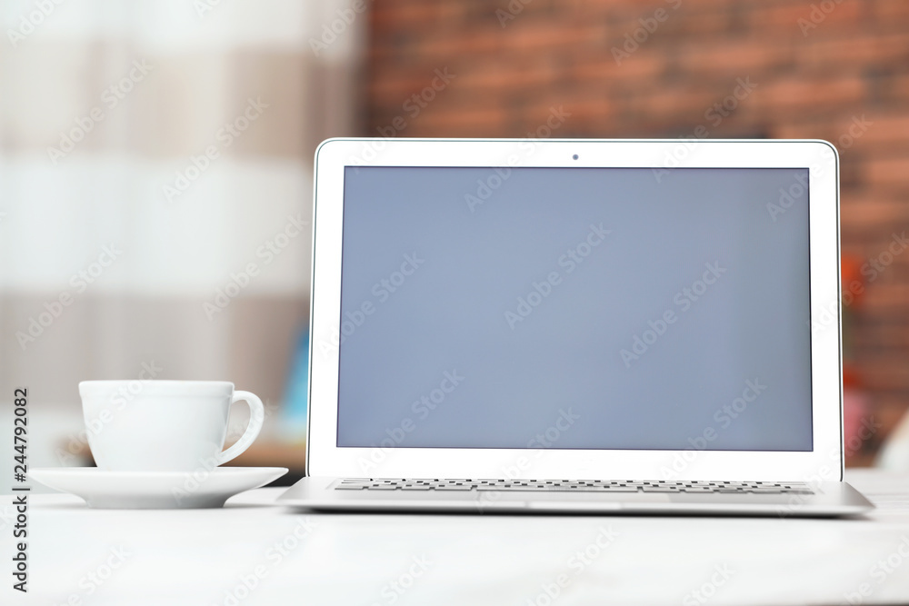 Laptop with blank screen on table indoors. Space for text Laptop with blank screen on table indoors. Space for text