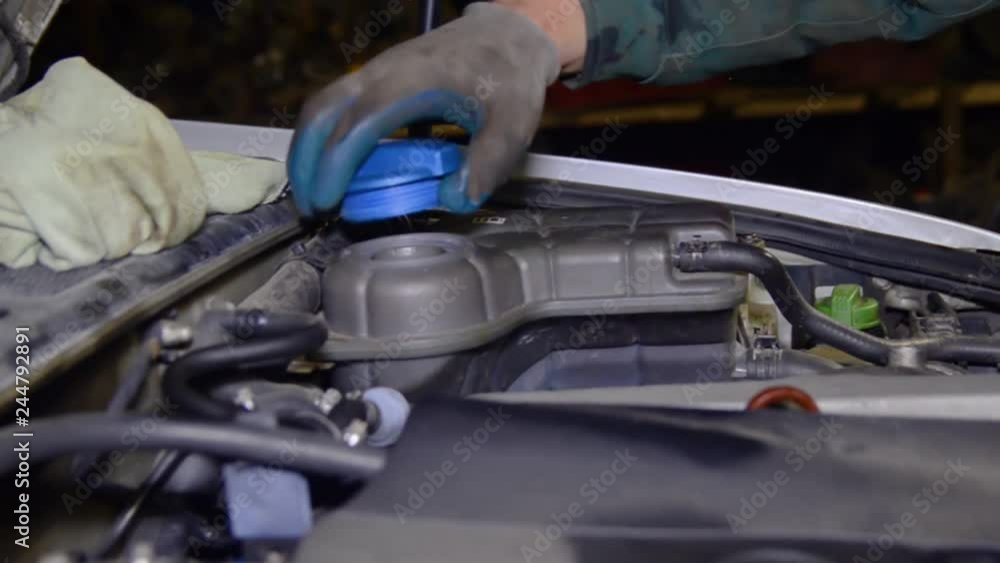 The mechanic tightened the valve on the brake tank and coolant. The mechanic tightened the valve on the brake tank and coolant.