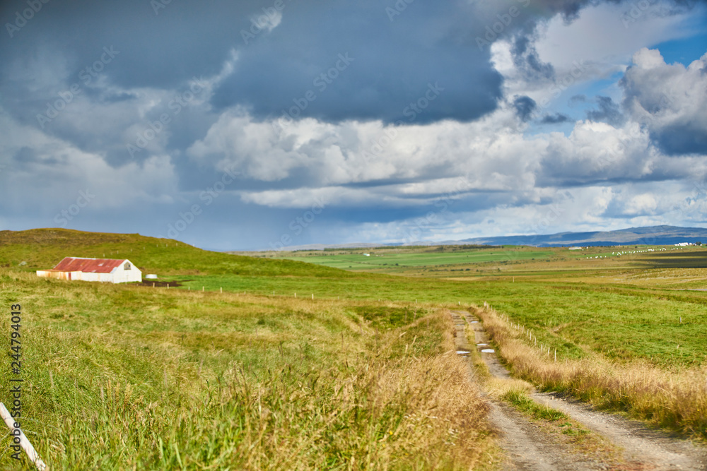 green field and blue sky and isolated farmhouse green field and blue sky and isolated farmhouse