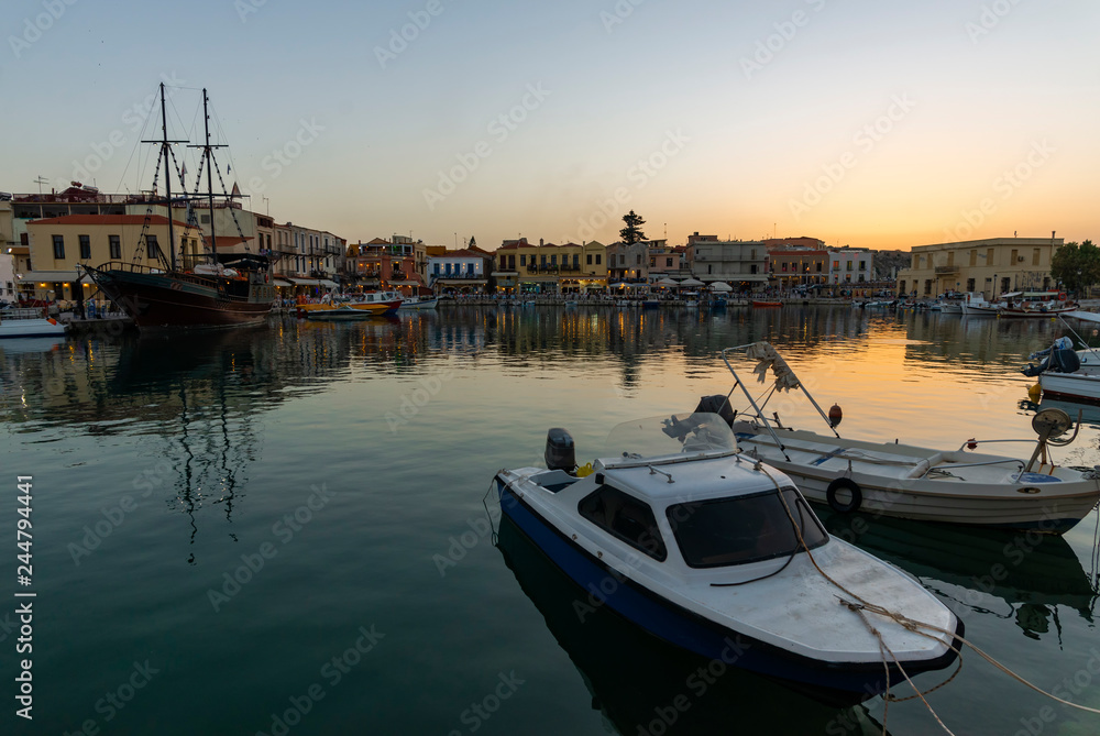 Greece, Crete Rethymnon. Old venetian harbor at the evening. Panoramic view on the port and sailing ship.