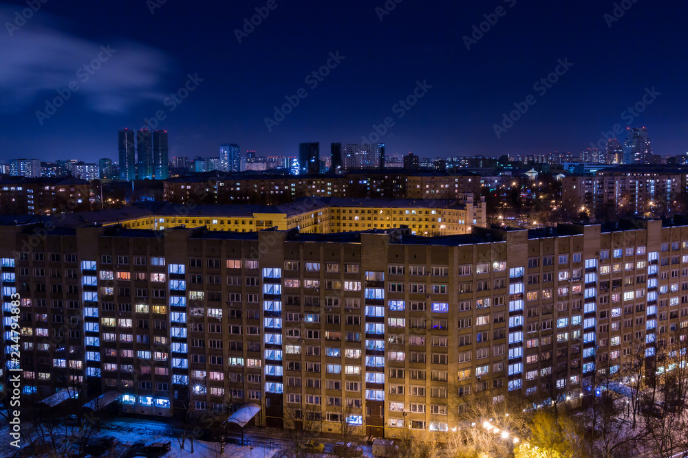 Evening or night city landscape. Lights in the Windows of apartment buildings.