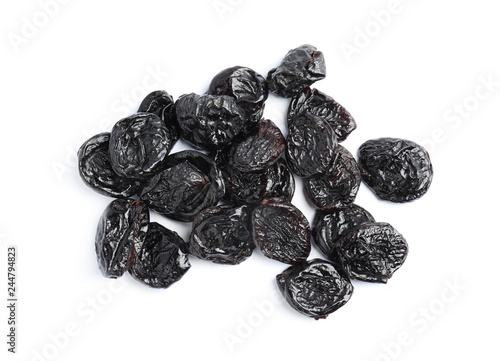 Heap of tasty prunes on white background, top view. Dried fruit as healthy snack