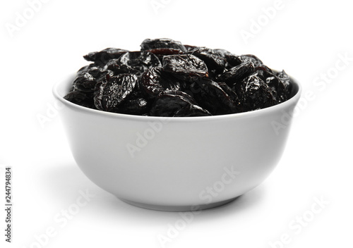 Bowl of tasty prunes on white background. Dried fruit as healthy snack