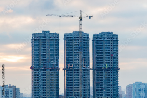 Construction of high-rise residential buildings in the big city. Winter cityscape at sunset. Moscow, Russia