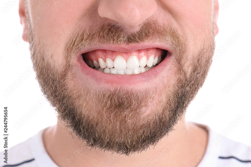Young man with healthy teeth smiling on white background, closeup Young man with healthy teeth smiling on white background, closeup