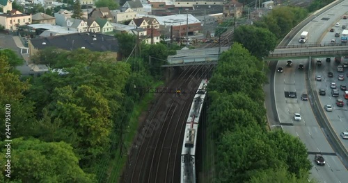 Aerial Following Shot of a Passing Train Near a Highway photo