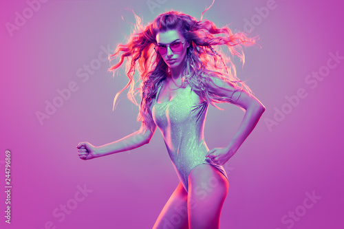 High Fashion neon light. Glamour Sexy Girl with Trendy Wavy Hairstyle, Stylish Sunglasses. Creative Bright Pink Vanilla Color. Design Art concept, party vibrations