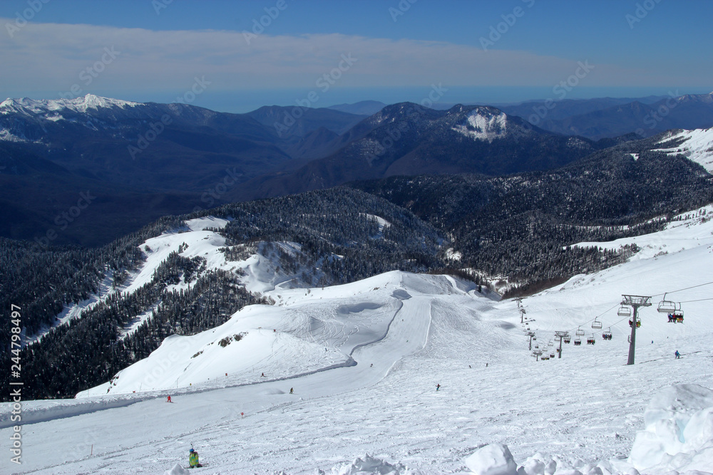 Sunny ski slopes of the snowy mountain resort Rosa Khutor, Sochi Russia