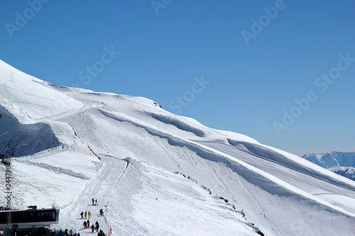 Sunny ski slopes of the snowy mountain resort Rosa Khutor, Sochi Russia photo