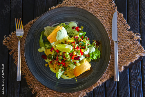 Burito with corn, bean, bell and chilli pepper, cucumber and onion