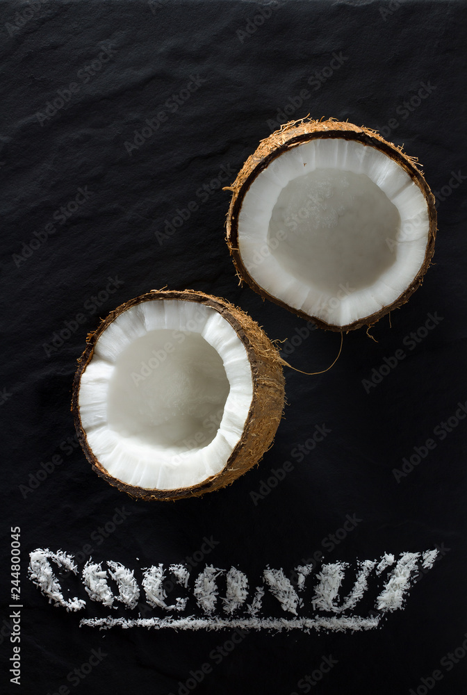 Ripe coconut split into two parts close-up on Ripe coconut split into two parts close-up on