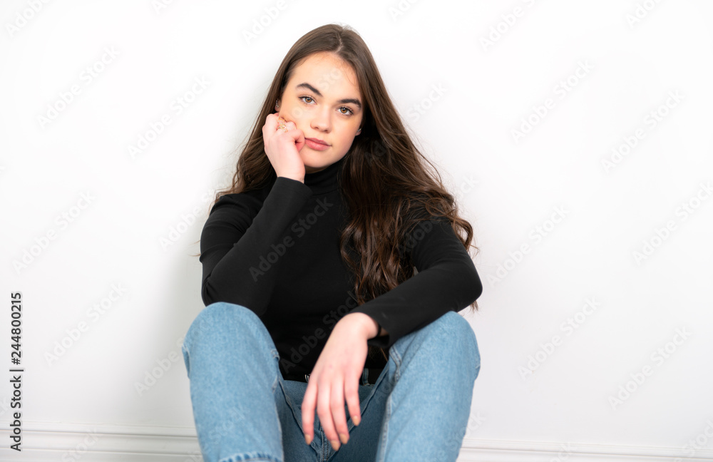 Portrait of a charming brunette little girl sit on white background Portrait of a charming brunette little girl sit on white background