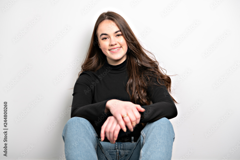 Portrait of a charming brunette little girl sit on white background Portrait of a charming brunette little girl sit on white background