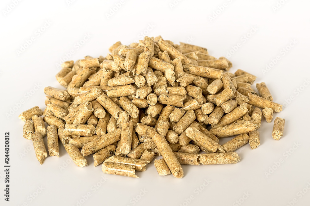 A heap of wooden pellets on white background. Alternative biofuel from sawdust for burning in furnaces and stoves. Cat and hamster litter. A heap of wooden pellets on white background. Alternative biofuel from sawdust for burning in furnaces and stoves. Cat and hamster litter.