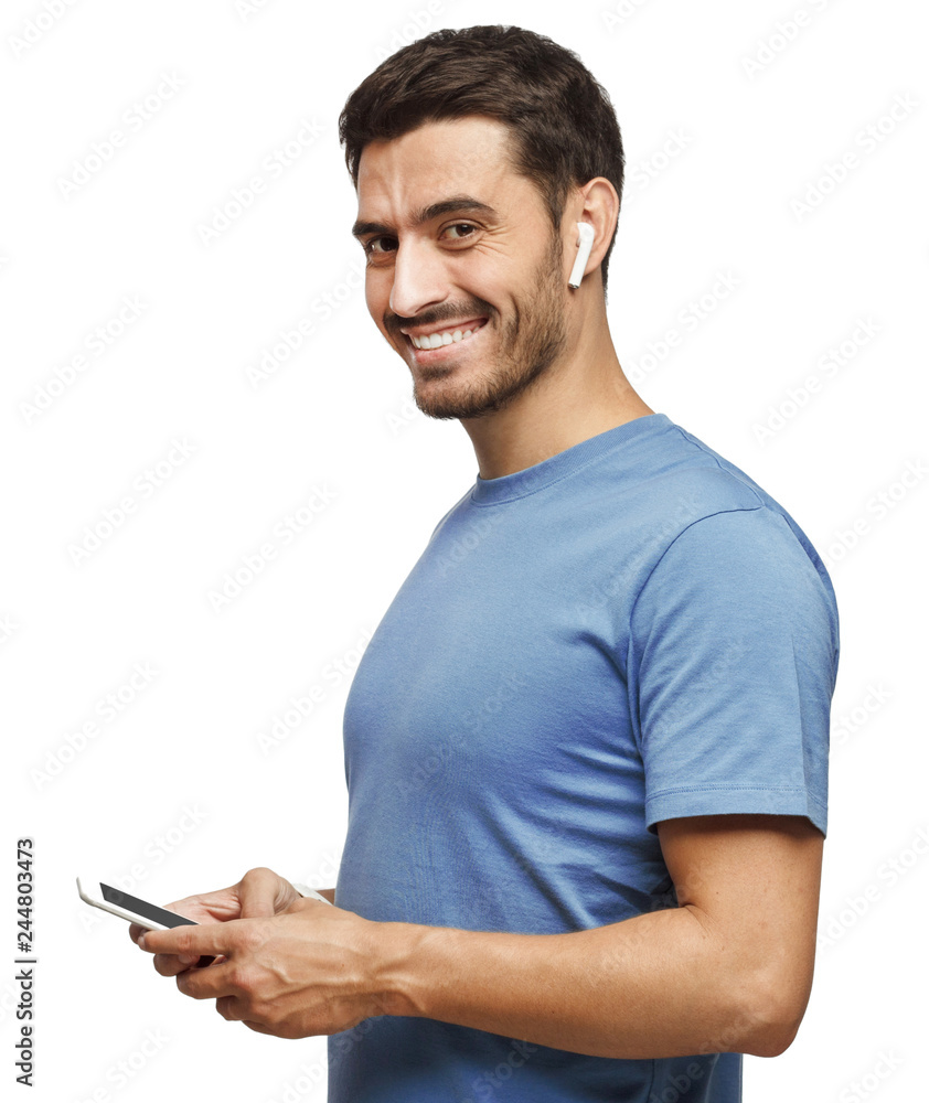 Young man looking and smiling at the camera, using mobile phone, isolated on white background Young man looking and smiling at the camera, using mobile phone, isolated on white background