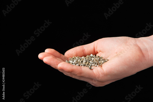Vermiculite in the hands of a woman. Close up. Soil growing cannabis. A mixture of earth, perlite and vermiculite.