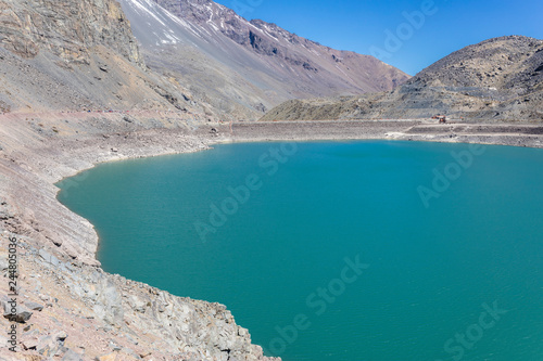 Embalse del Yeso (Yeso Dam) awe high altitude turquoise waters lake inside an amazing rugged landscape. Steep mountains on an awe scenery with the river stopped by the dam inside Andes mountains 