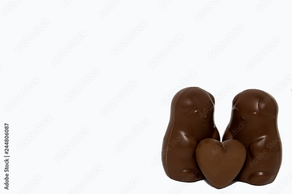 pair of chocolate bears with chocolate heart on a white background love Valentine's day isolate pair of chocolate bears with chocolate heart on a white background love Valentine's day isolate
