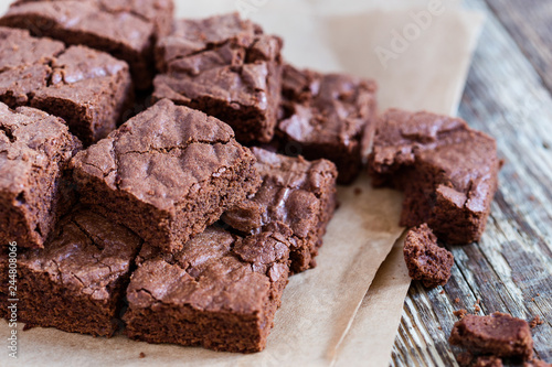 Pieces of freshly baked chocolate brownie on rustic wooden board