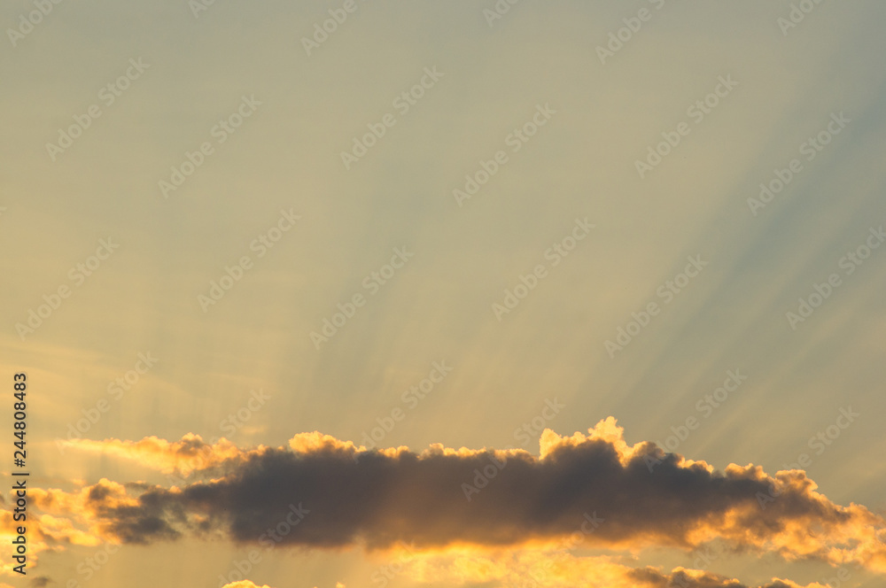 Fototapeta premium Landscape with dramatic light - beautiful golden sunset with saturated sky and clouds.