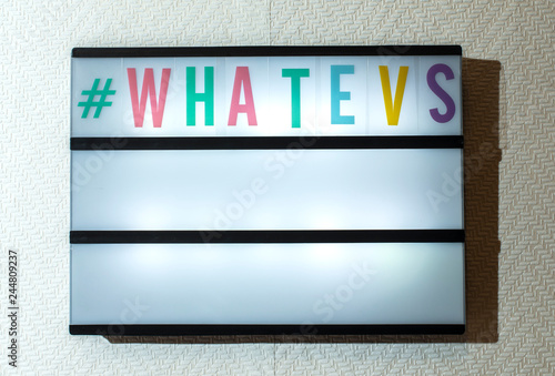 Message #whatevs on illuminated board. Incuriosity concept with text. photo