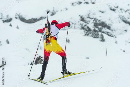 Winter sports. A participant in a biathlon competition, in a winter season in Spain, in a snowy landscape. photo