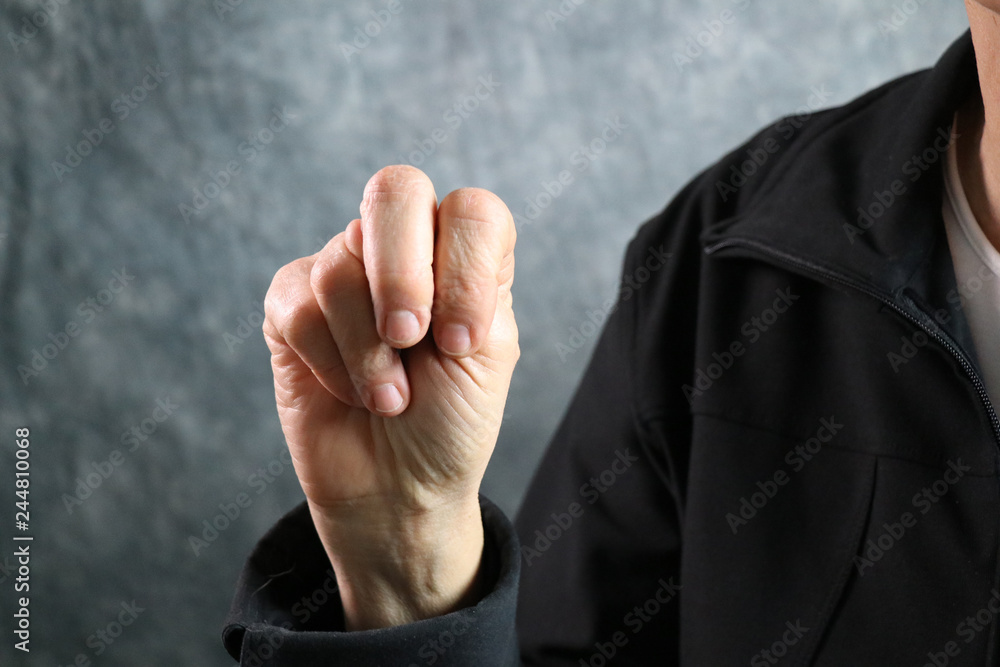 American Sign Language (ASL) letter N held in correct position next to