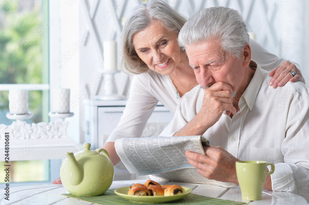 Close-up portrait of a senior couple with newspaper Close-up portrait of a senior couple with newspaper
