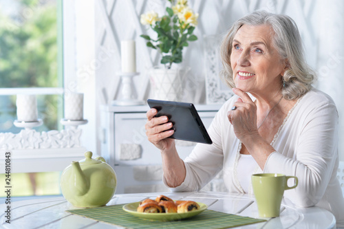 Portrait of senior woman with tablet pc