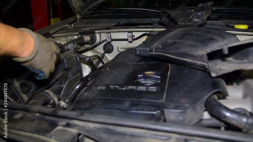 Auto mechanic working in the garage. Repair service. repairs under the hood. Auto mechanic working in the garage. Repair service. repairs under the hood.