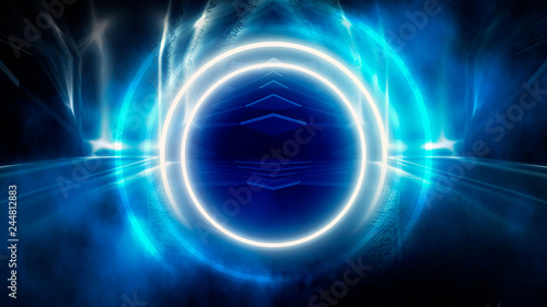 Round abstract tunnel, blue neon. Neon circle light arch, in the center, light, rays, smoke. Abstract blue background with rays and neon. © MiaStendal