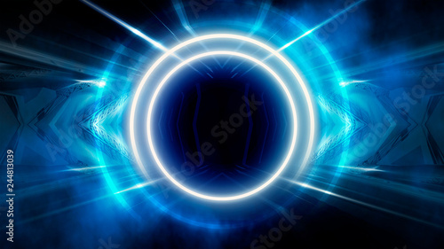 Round abstract tunnel, blue neon. Neon circle light arch, in the center, light, rays, smoke. Abstract blue background with rays and neon.