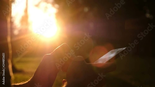 Wallpaper Mural Man using smartphone. Close up shot of man hands with mobile on sunset. Relax, nature concept. Torontodigital.ca