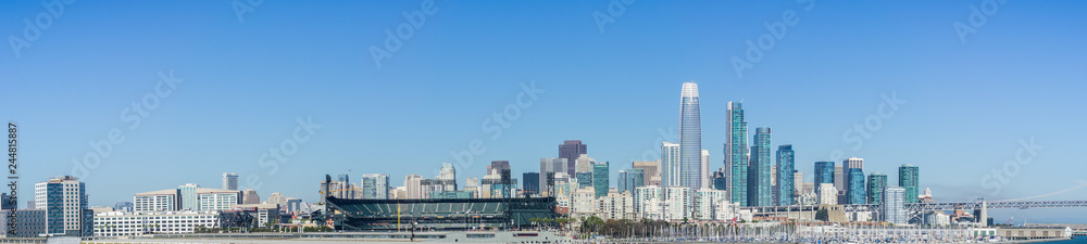 Panoramic view of San Francisco skyline as seen from the waterfront on a sunny and clear day Panoramic view of San Francisco skyline as seen from the waterfront on a sunny and clear day