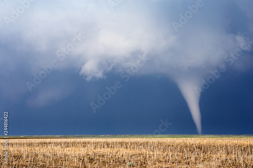 Dramatic tornado and severe storm over a field in Nebraska photo