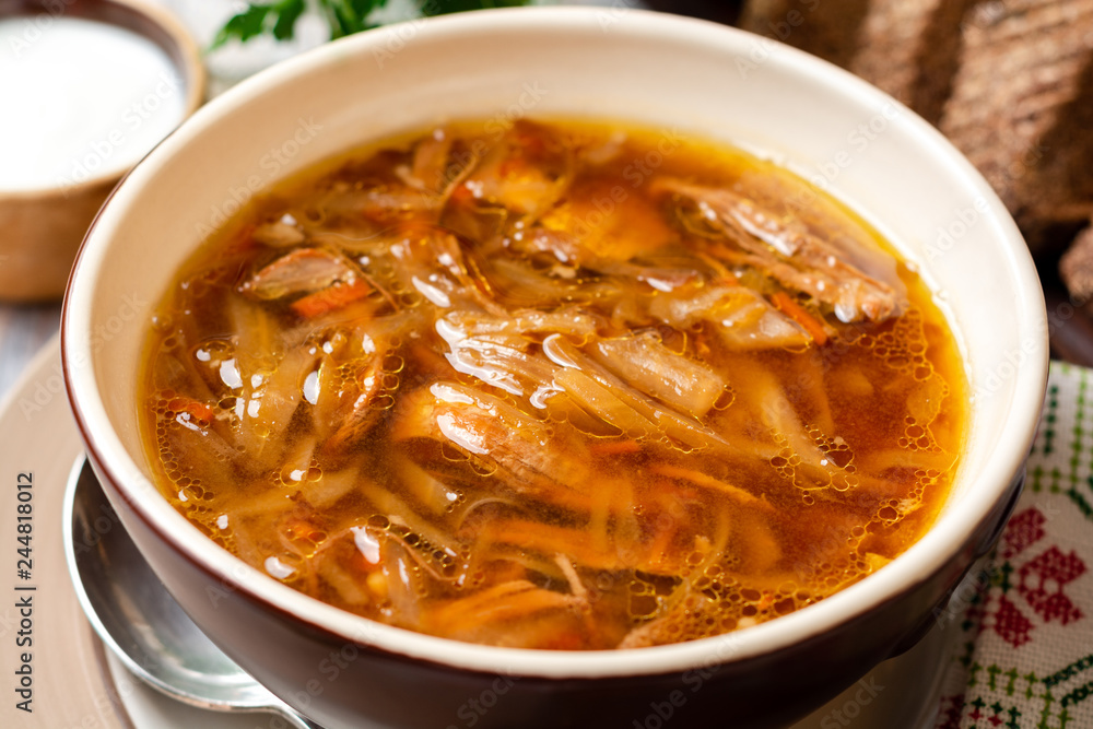 Traditional Russian sauerkraut soup Shchi in bowl on rustic wooden background. Selective focus. Traditional Russian sauerkraut soup Shchi in bowl on rustic wooden background. Selective focus.
