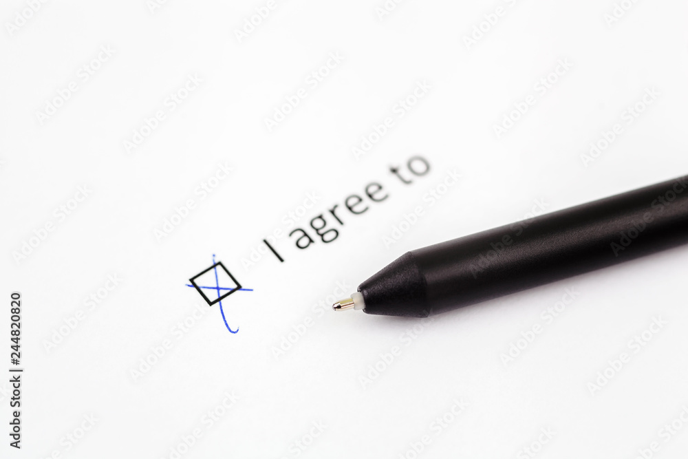 I agree to - checkbox with a check mark on white paper with pen. Checklist concept I agree to - checkbox with a check mark on white paper with pen. Checklist concept