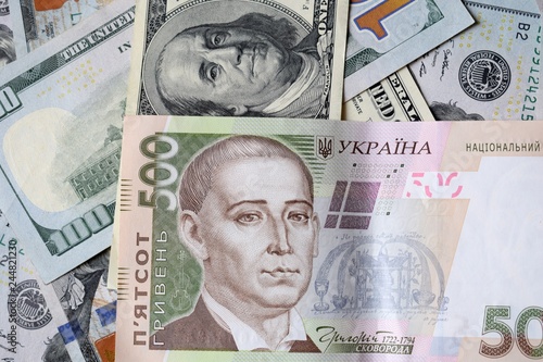 Ukrainian money - 500 hryvnia banknotes USA 100 dollars bills. Finance crisis in Ukraine, the fall of the hryvnia to the dollar exchange rate. Money background