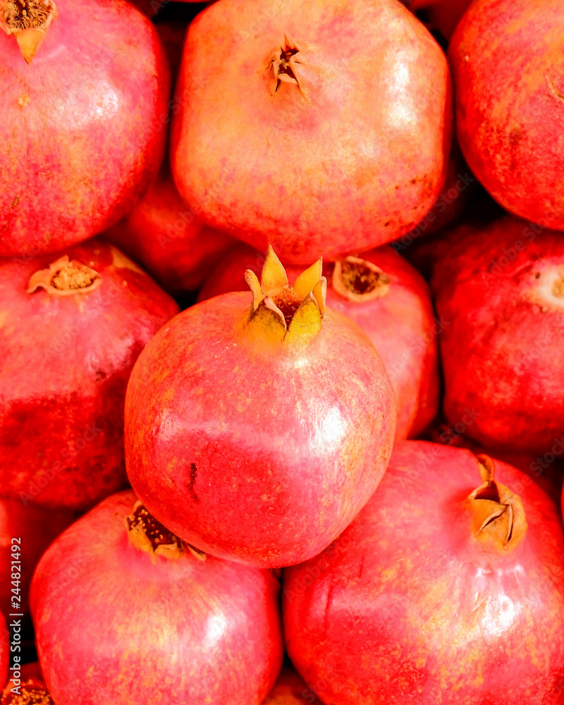 raw pomegranates top view closeup, natural background