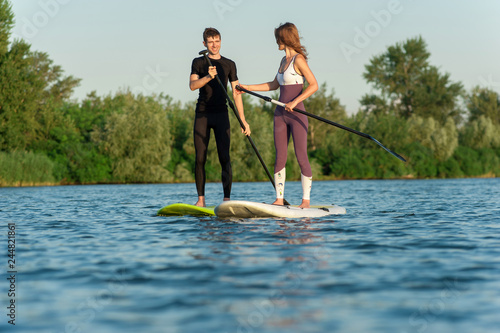 Sporting couple enjoying outdoor activities on loch