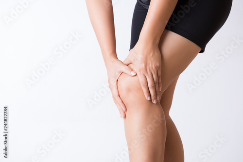 Runner sport knee injury. Closeup young woman in knee pain while running. Healthcare and medical concept. photo