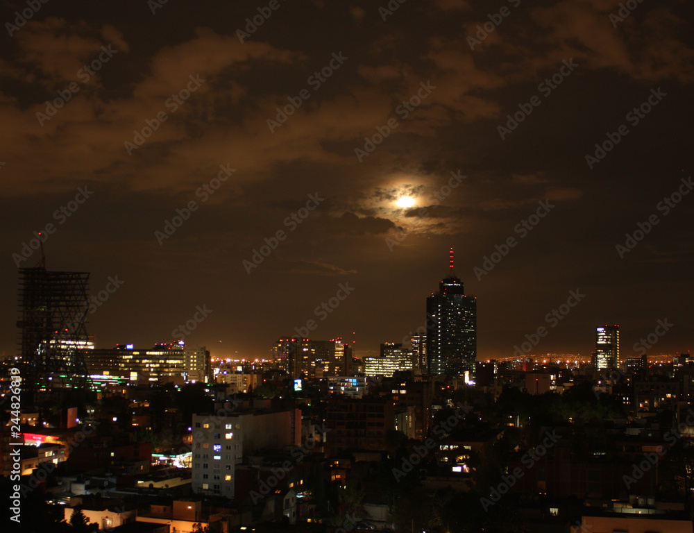 Clouds in dramatic scene on blue blood moon night in Mexico City