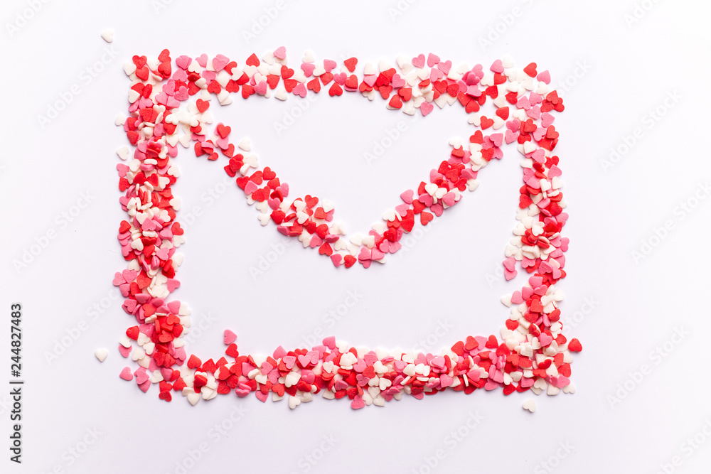 envelope shape on white background made of red white and pink hearts sweets. Top view. Valentine day. love concept. Gift, message for lover. Space for text envelope shape on white background made of red white and pink hearts sweets. Top view. Valentine day. love concept. Gift, message for lover. Space for text