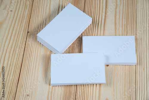 Blank business cards on wooden working table with copy space for add text ID. and logo, business company concept.